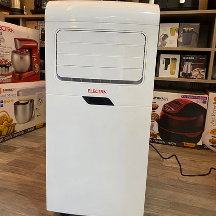 A white Electra portable air conditioner and heater standing on a gray wood floor in a retail store, with product boxes and other appliances visible in the background.