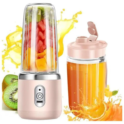 Portable blender with fruits inside and a juice cup filled with orange juice on a white background.