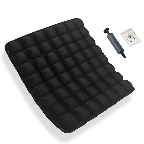 Black inflatable air mattress with a grid of bubble chambers, shown with a black hand pump and a small instruction booklet on a white background.